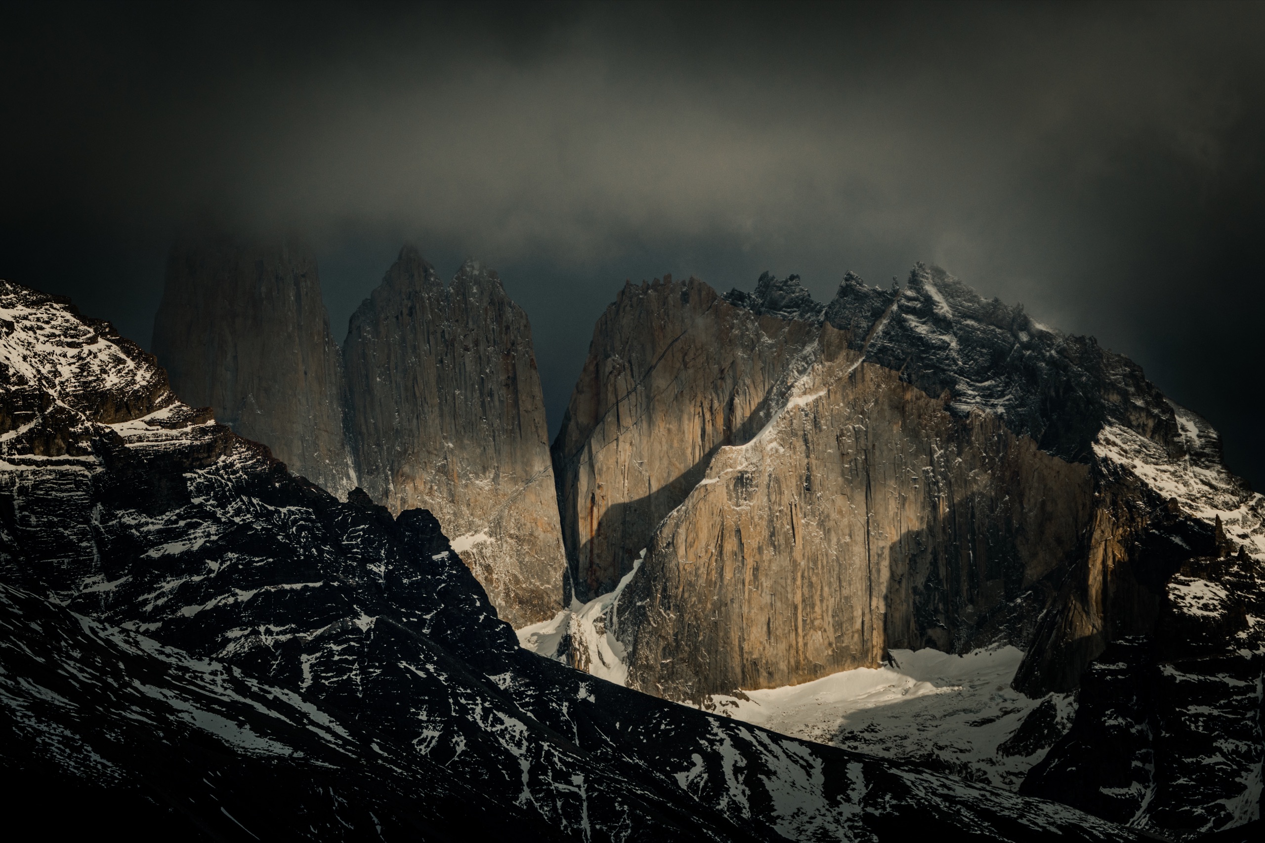 The towers of Torres del Paine in dark storm light